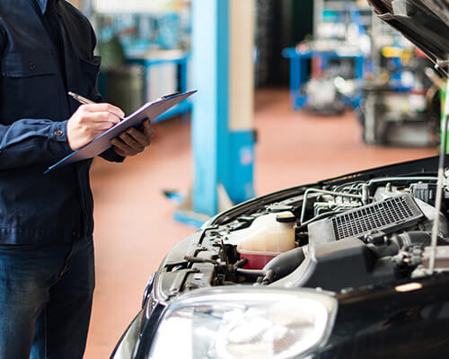 A Mechanic Checking over a car's engine